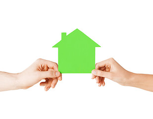 Image showing man and woman hands with green paper house