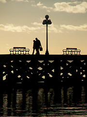 Image showing Silhouette of Couple Walking On Pier At Dusk