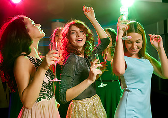 Image showing smiling friends with glasses of champagne in club