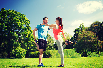 Image showing smiling couple stretching outdoors