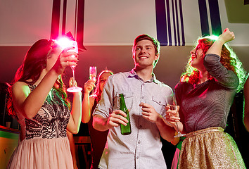 Image showing smiling friends with wine glasses and beer in club