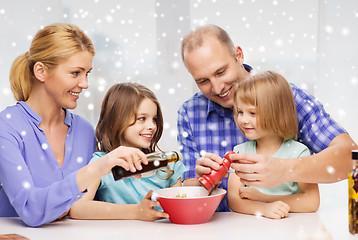 Image showing happy family with two kids making salad at home