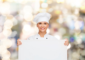 Image showing smiling female chef with white blank board