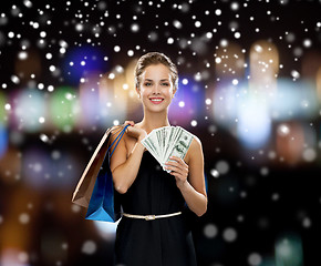 Image showing smiling woman in dress with shopping bags