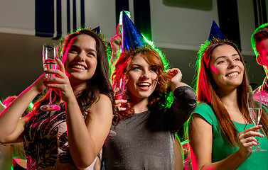 Image showing smiling friends with glasses of champagne in club