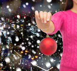 Image showing close up of woman in sweater with christmas ball