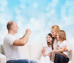 Image showing happy family with camera at home