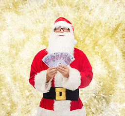 Image showing man in costume of santa claus with euro money