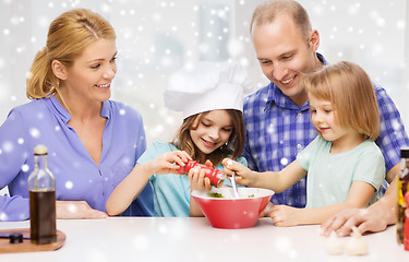 Image showing happy family with two kids making salad at home