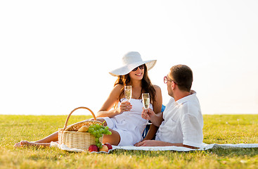 Image showing smiling couple drinking champagne on picnic