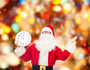 Image showing man in costume of santa claus with clock