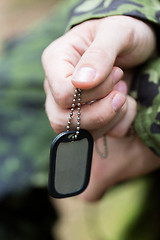 Image showing close up of young soldier in military uniform