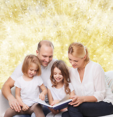 Image showing happy family with book at home