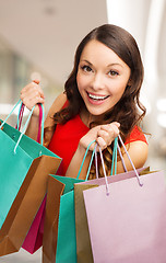 Image showing smiling young woman with shopping bags