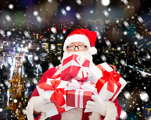 Image showing man in costume of santa claus with gift boxes