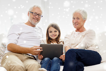 Image showing smiling family with tablet pc at home