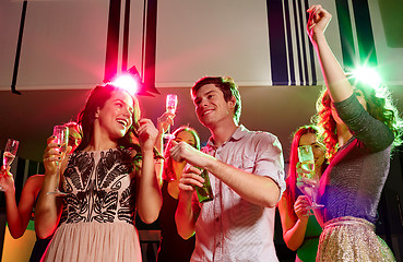 Image showing smiling friends with wine glasses and beer in club