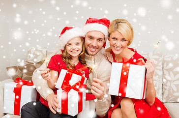 Image showing happy family with gifts and sparklers