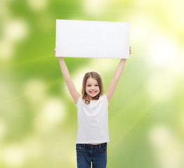 Image showing smiling little girl holding blank white board