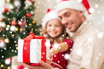 Image showing smiling father and daughter holding gift box