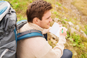 Image showing smiling man with backpack hiking