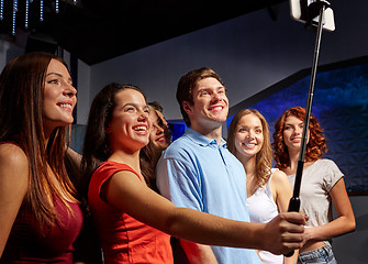 Image showing friends with smartphone taking selfie in club