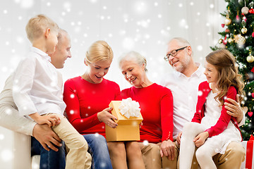 Image showing smiling family with gifts at home