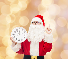 Image showing man in costume of santa claus with clock