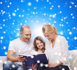 Image showing happy family with book at home