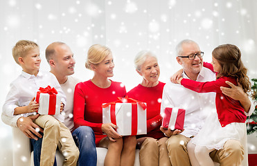 Image showing smiling family with gifts at home