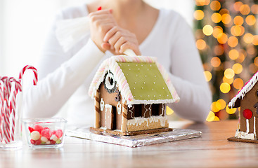 Image showing close up of woman making gingerbread houses