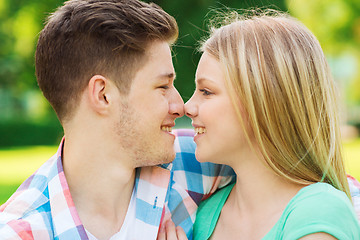 Image showing smiling couple touching noses in park