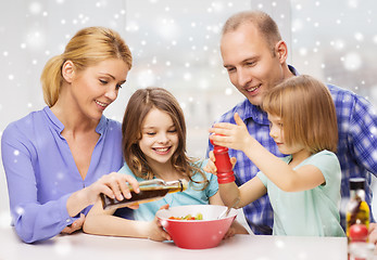 Image showing happy family with two kids making salad at home