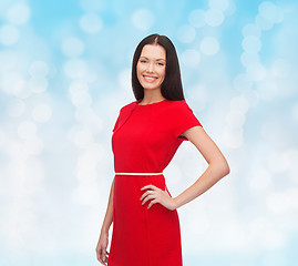 Image showing smiling woman in red dress