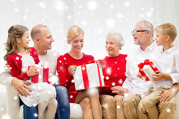 Image showing smiling family with gifts at home