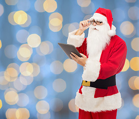 Image showing man in costume of santa claus with tablet pc