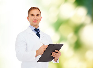 Image showing smiling male doctor with clipboard