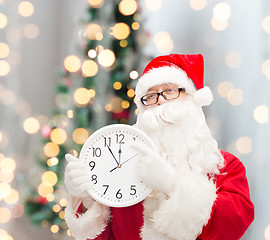 Image showing man in costume of santa claus with clock