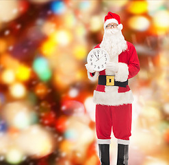 Image showing man in costume of santa claus with clock