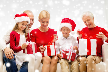 Image showing smiling family with gifts at home