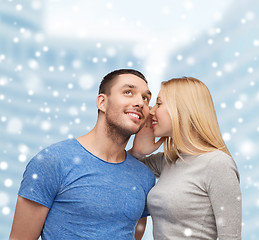 Image showing smiling girlfriend telling boyfriend secret