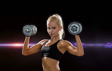 Image showing sporty woman with heavy steel dumbbells