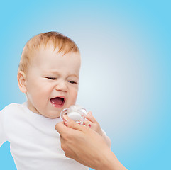 Image showing crying baby with dummy