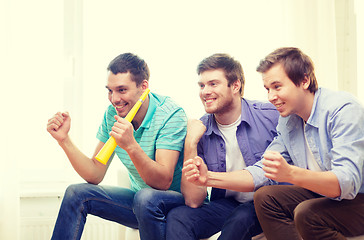 Image showing happy male friends with vuvuzela watching sports