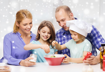 Image showing happy family with two kids making salad at home