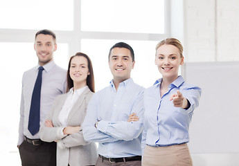 Image showing businesswoman in office pointing finger at you