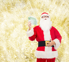 Image showing man in costume of santa claus with euro money