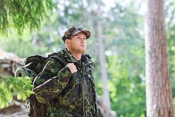 Image showing young soldier with backpack in forest