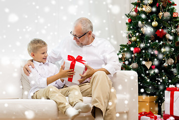 Image showing smiling grandfather and grandson at home