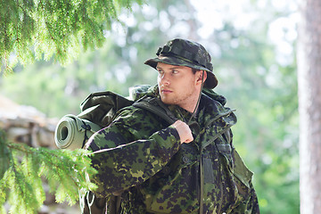 Image showing young soldier with backpack in forest